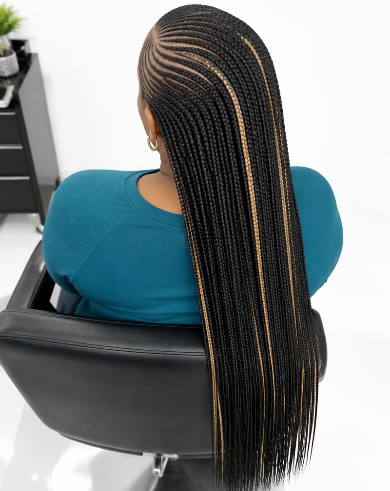 Feed-in cornrows into long micro braids with blonde accents